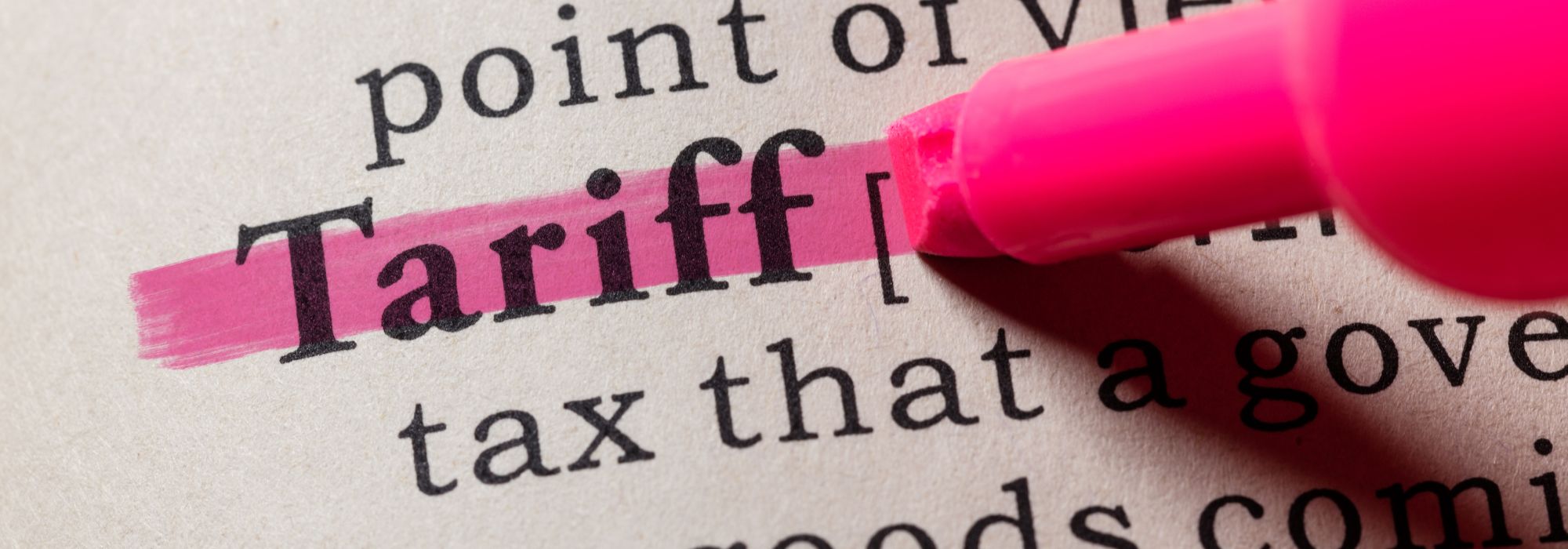 A pink highlighter highlighting the word Tariffs in a dictionary  